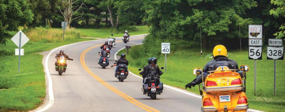Motorcyclists signaling to each other on the road.