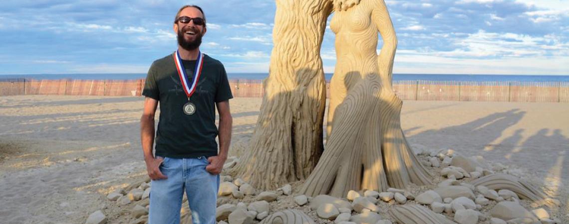 Carl Jara, a professional sand sculptor, pictured with one of his pieces of work.