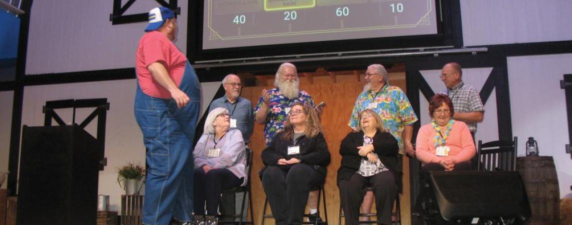 A group of people playing a gameshow-style game during a land cruise