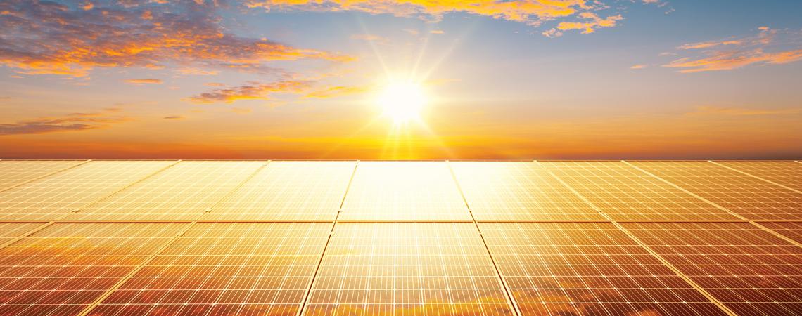 A sunset shining on solar panels