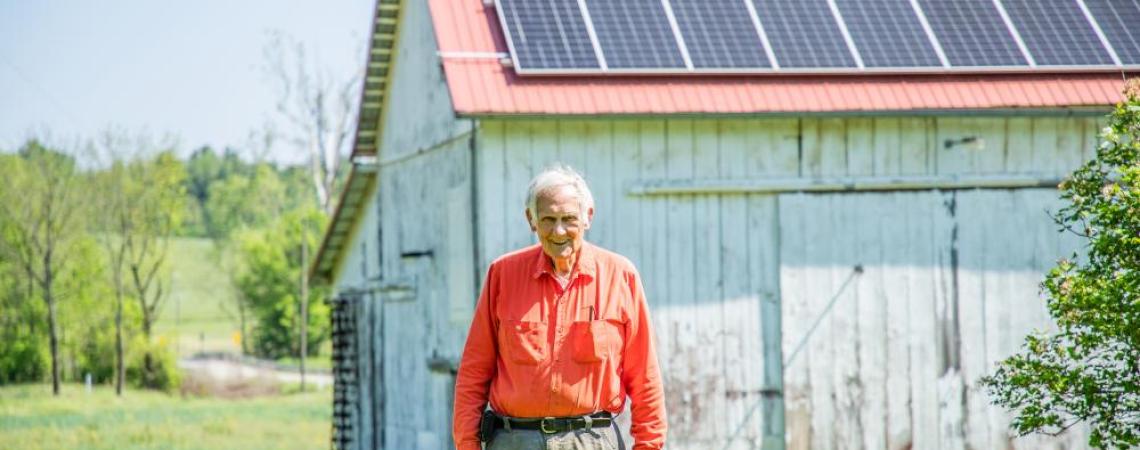Gary Kinzel posing with one of his barns