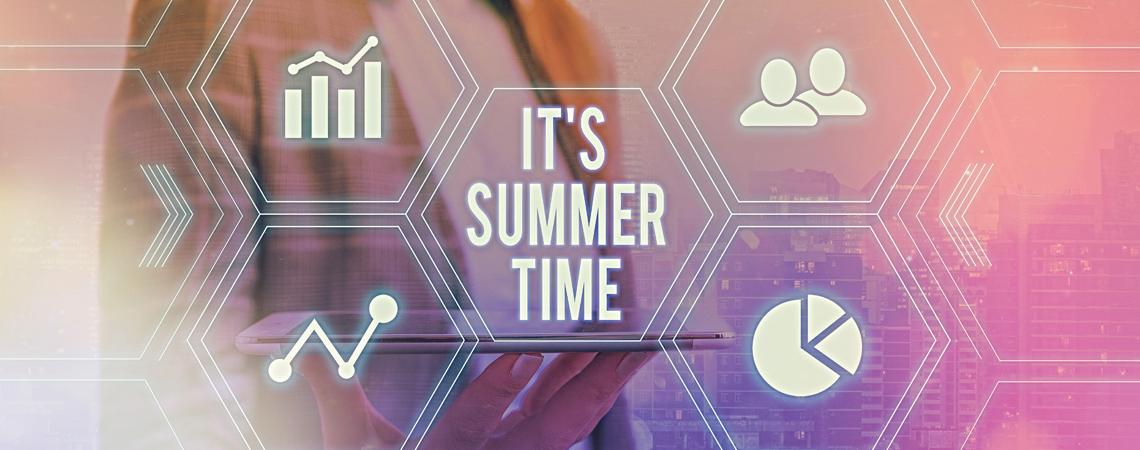 A hand holding a tablet with virtual text hovering above "It's summer time"