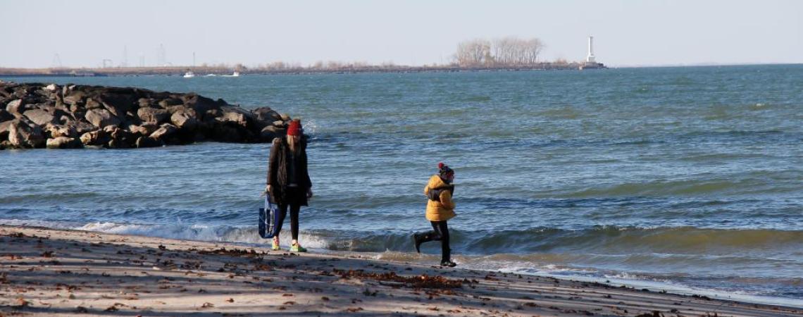 A mother and son walking on a beach