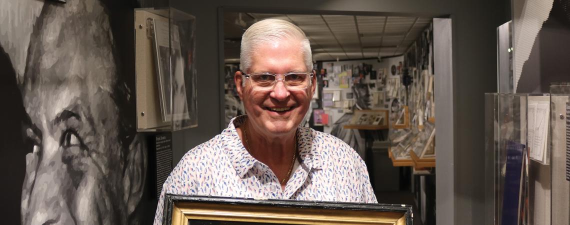 John Herzig holding a memento from Abraham Lincoln's funeral service