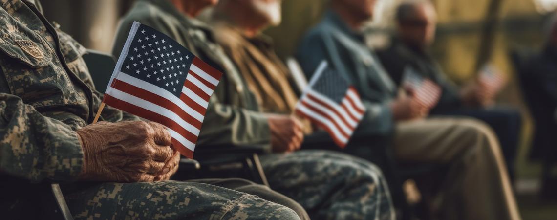 Military service is not always about fighting wars. It’s about growing up. Building confidence. Learning self-discipline. It’s about being part of something bigger than yourself. Veterans sitting with American flags