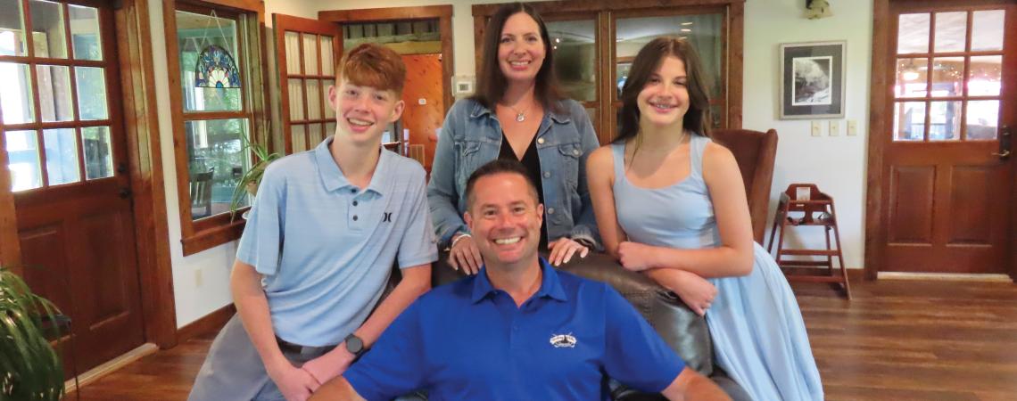 The Loomis family (from left), Carter, Zac, Lauren, and Quinn, is the second family to own and operate the Inn and Spa at Cedar Falls since it opened in 1987. A family of four posing for a photo