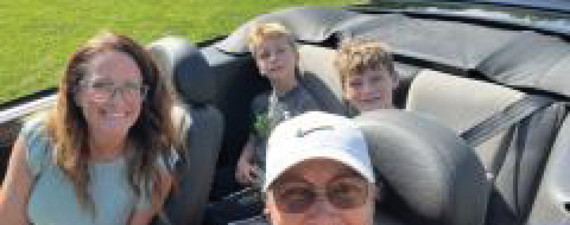 A group of people in a convertible