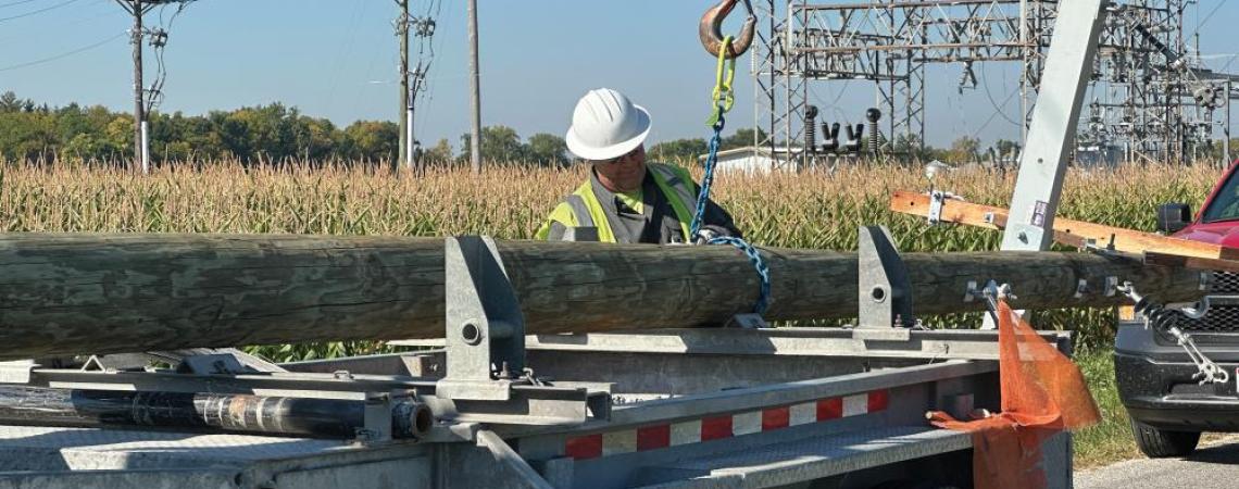 Line worker getting materials from truck bed