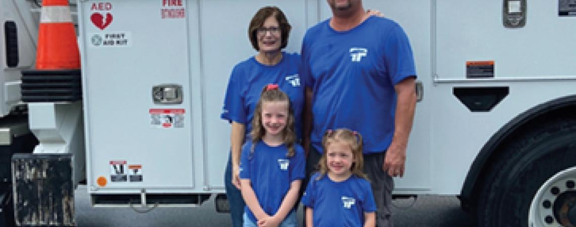family in front of truck