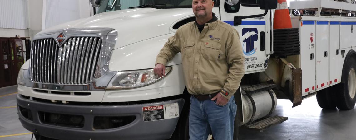 lineworker in front of truck