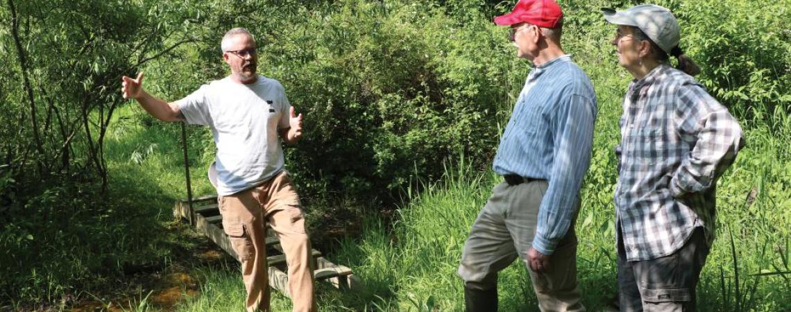 Three people talking in an outdoor space