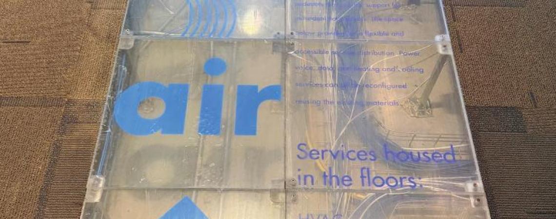 A glass section of flooring showing underground geothermal system