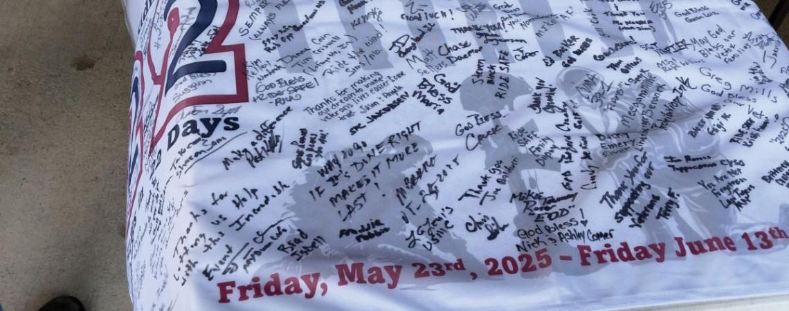 A flag covered with signatures of participants of Riding 22 in 22 VSA's 22-day motorcycle ride