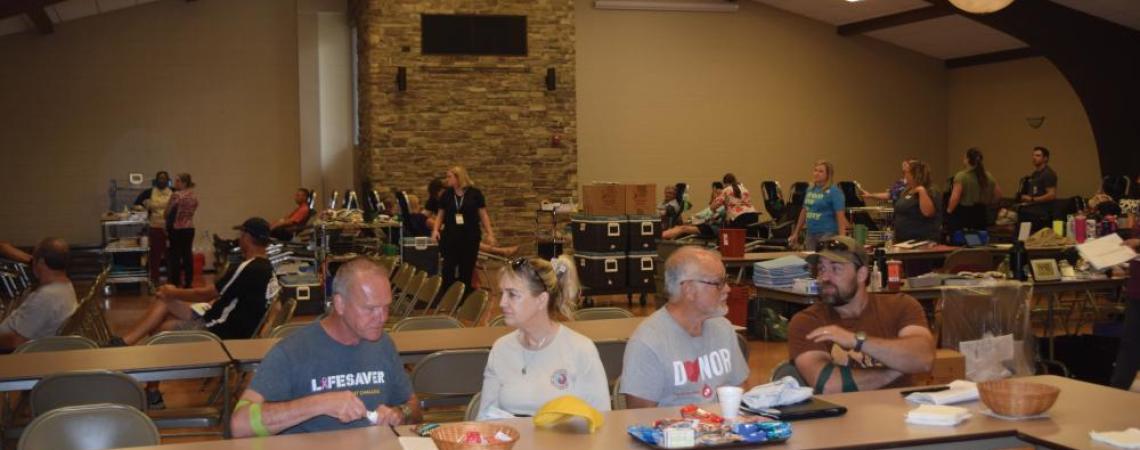 A group of people eating lunch after donating blood at a blood drive.