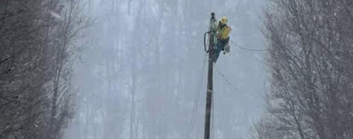 A lineworker on a utility pole