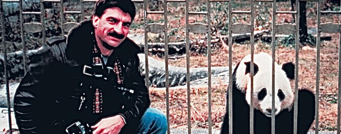 A man posing with a panda