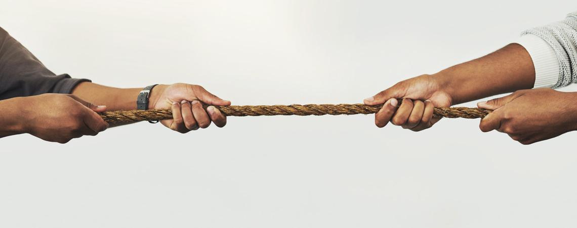 Two people pulling on a rope