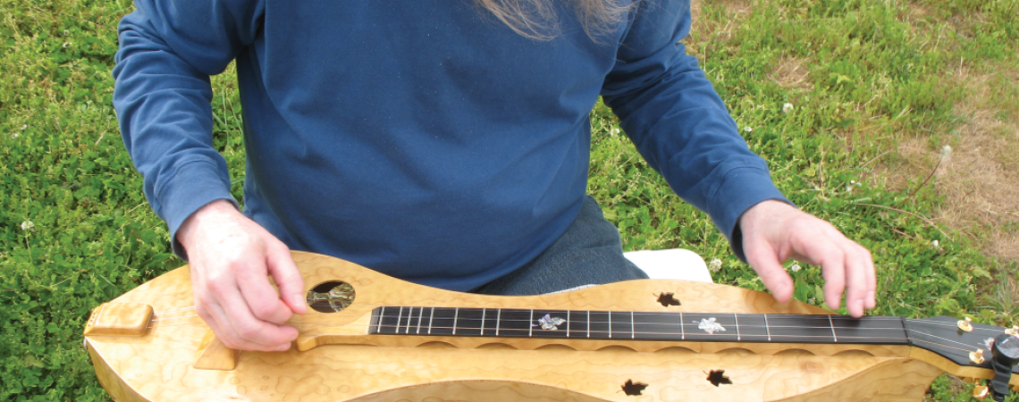 A man playing a mountain dulcimer