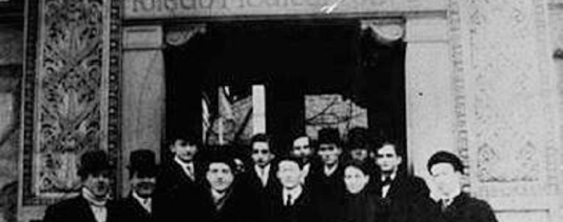 A black and white photo of a group of men standing at the entrance to a hospital