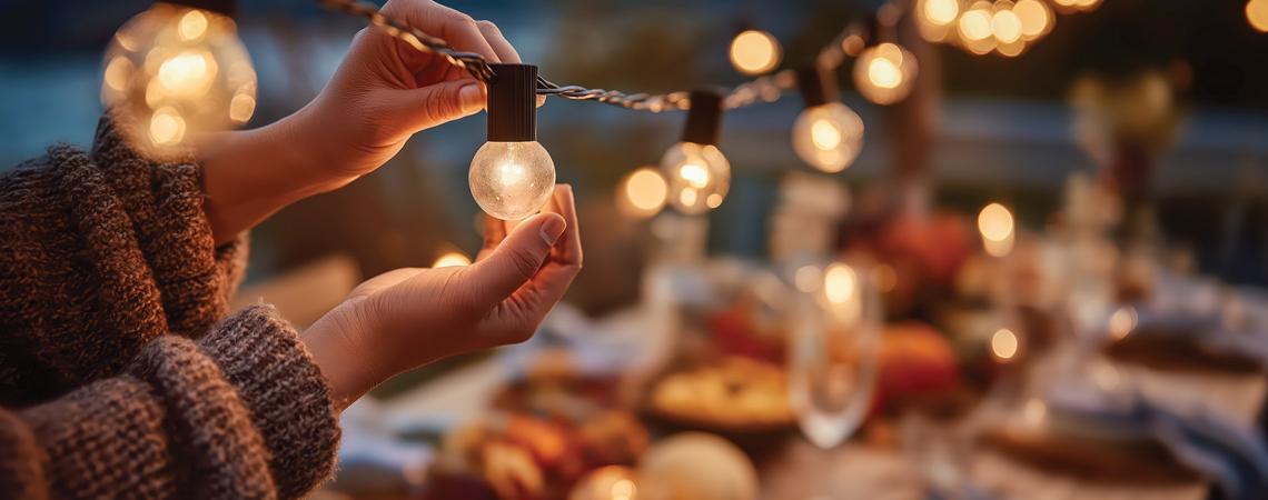 Hands holding a strand of outdoor lights